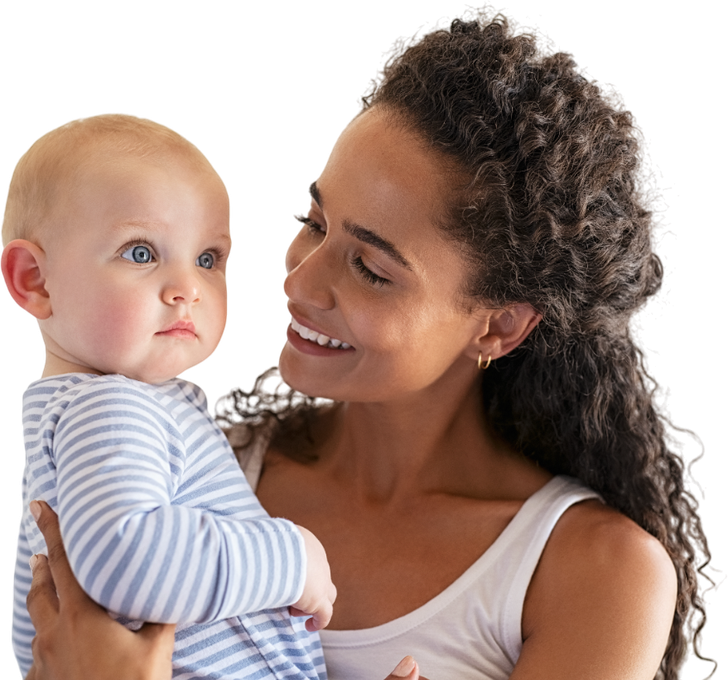 A woman is holding a baby in her arms and smiling