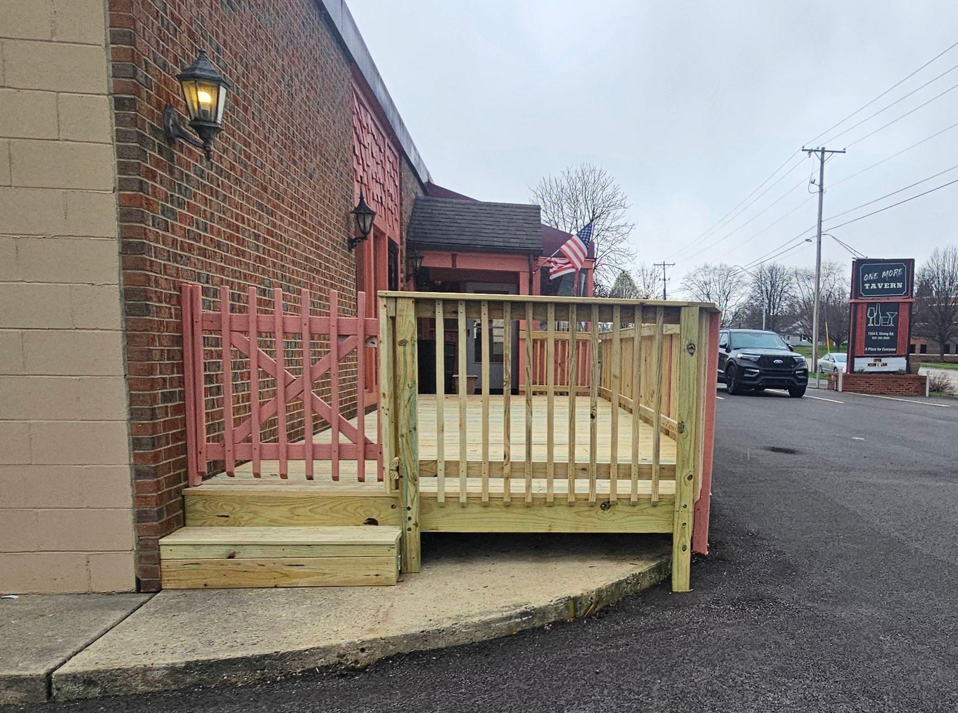 A brick building with a wooden deck in front of it
