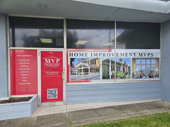 A building with a red door that says home improvement mvps