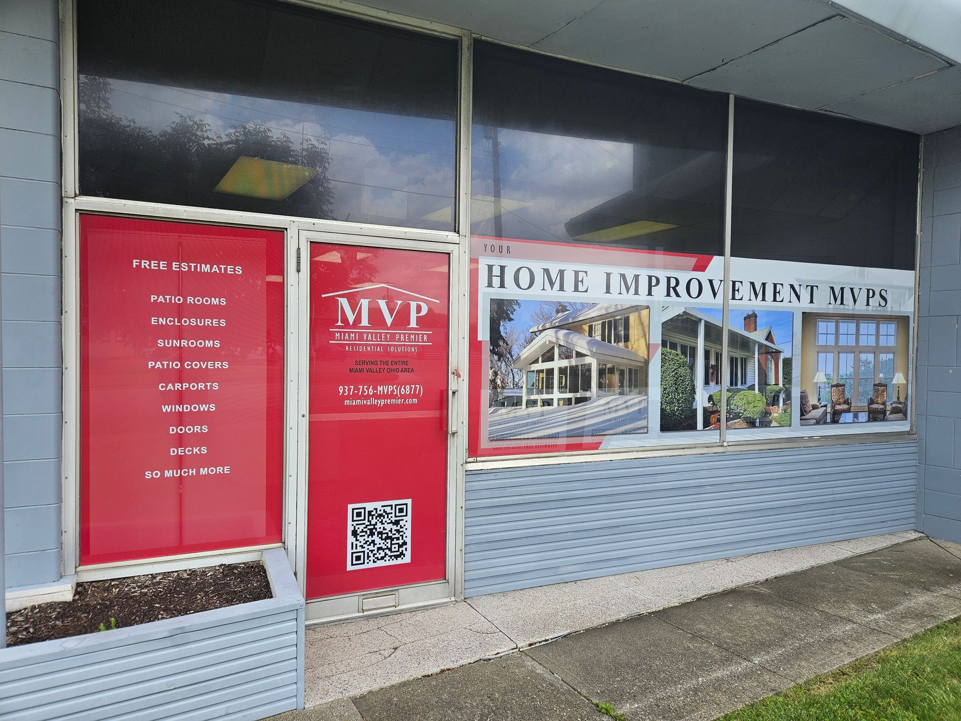 A building with a red door and a sign that says home improvement mvp