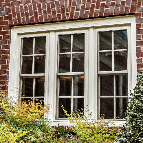 A window on a brick building with a white frame