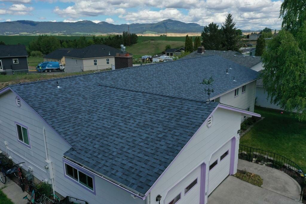 An aerial view of a house with a blue roof.