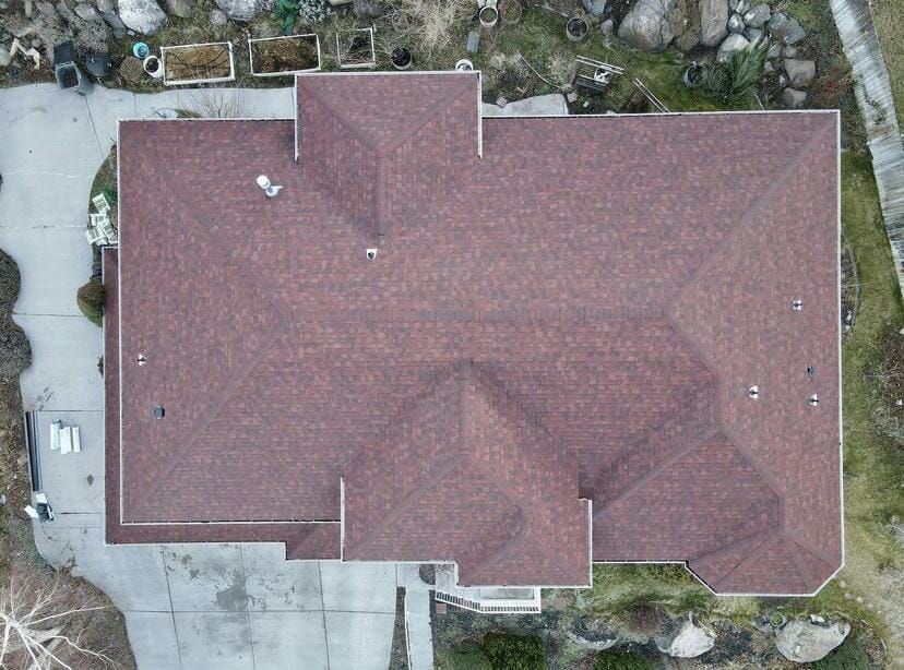 An aerial view of a large house with a red roof
