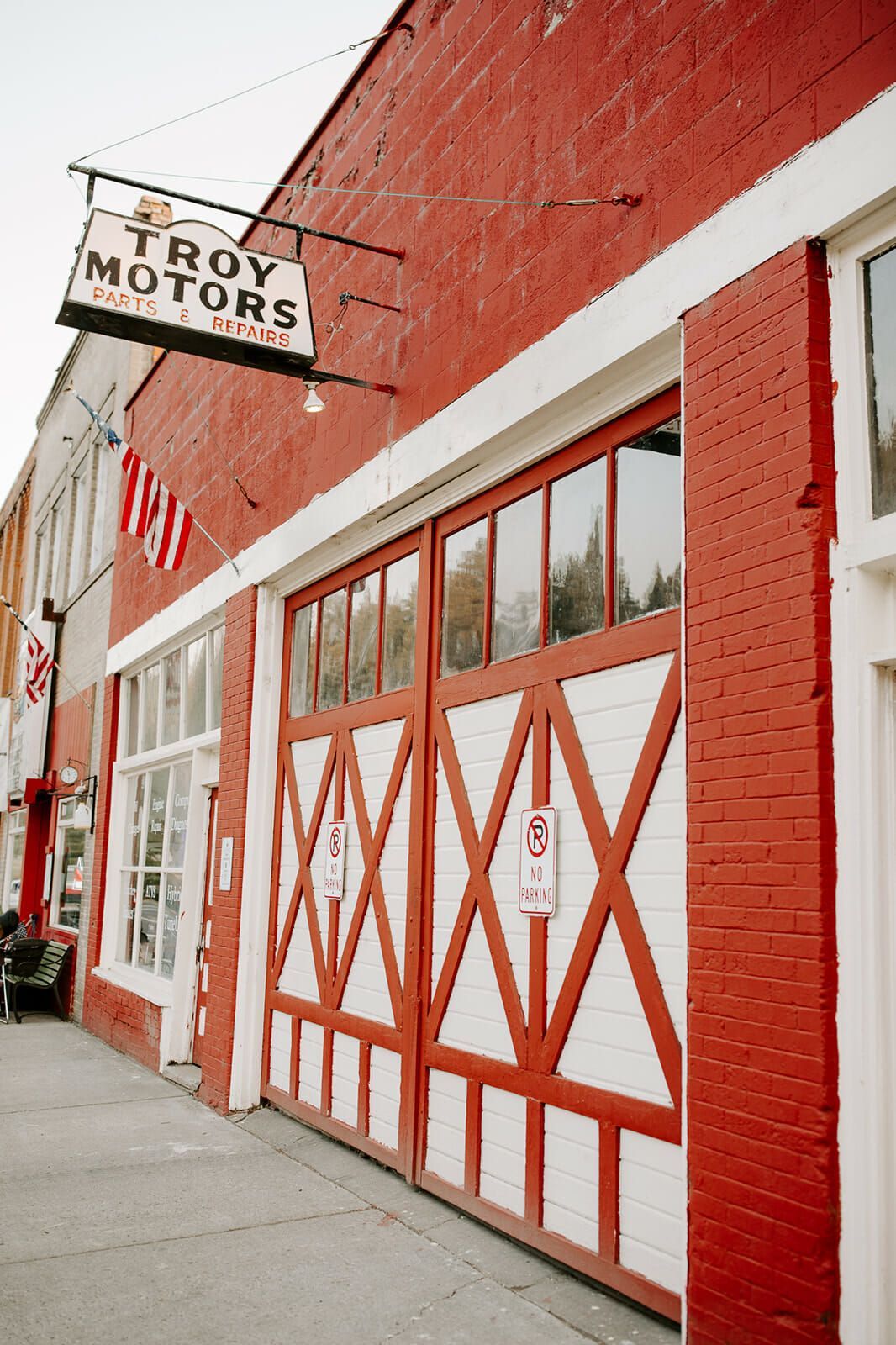 A red brick building with a sign that says troy motors on it.