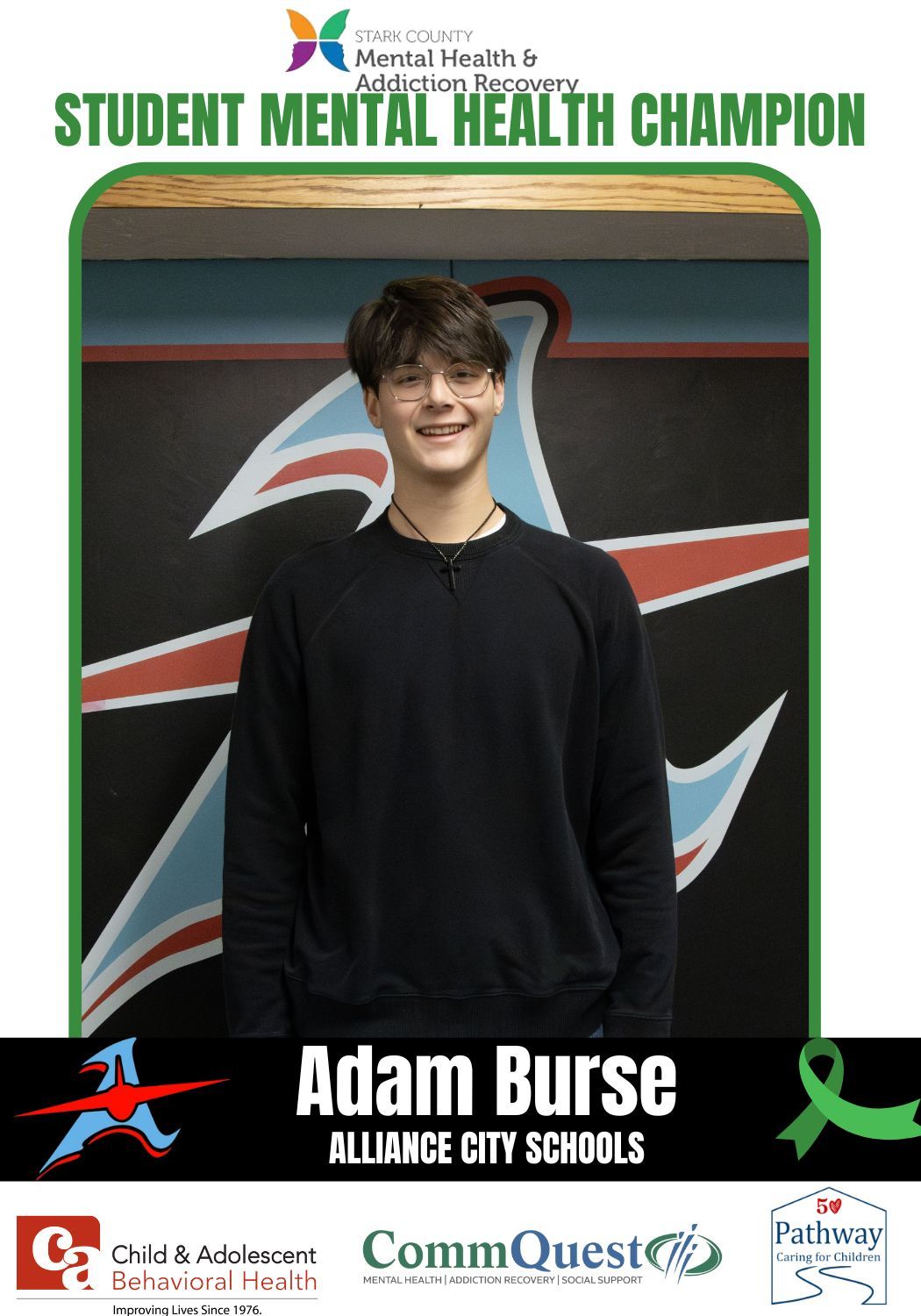 Adam Burse, student mental health champion, stands in front of a school logo.