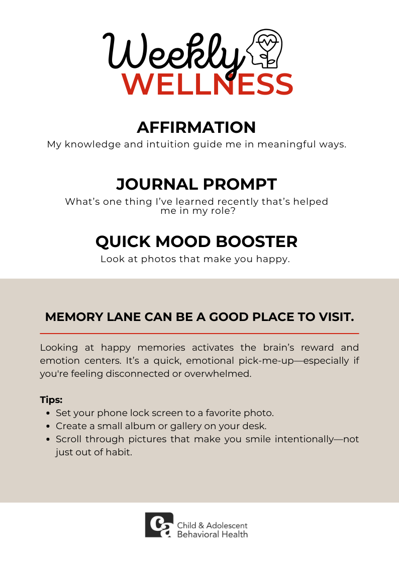 Woman in teal shirt, smiling with eyes closed, holding a red heart against a pink background.