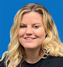 Woman with blonde hair smiling, wearing a black sweatshirt with 