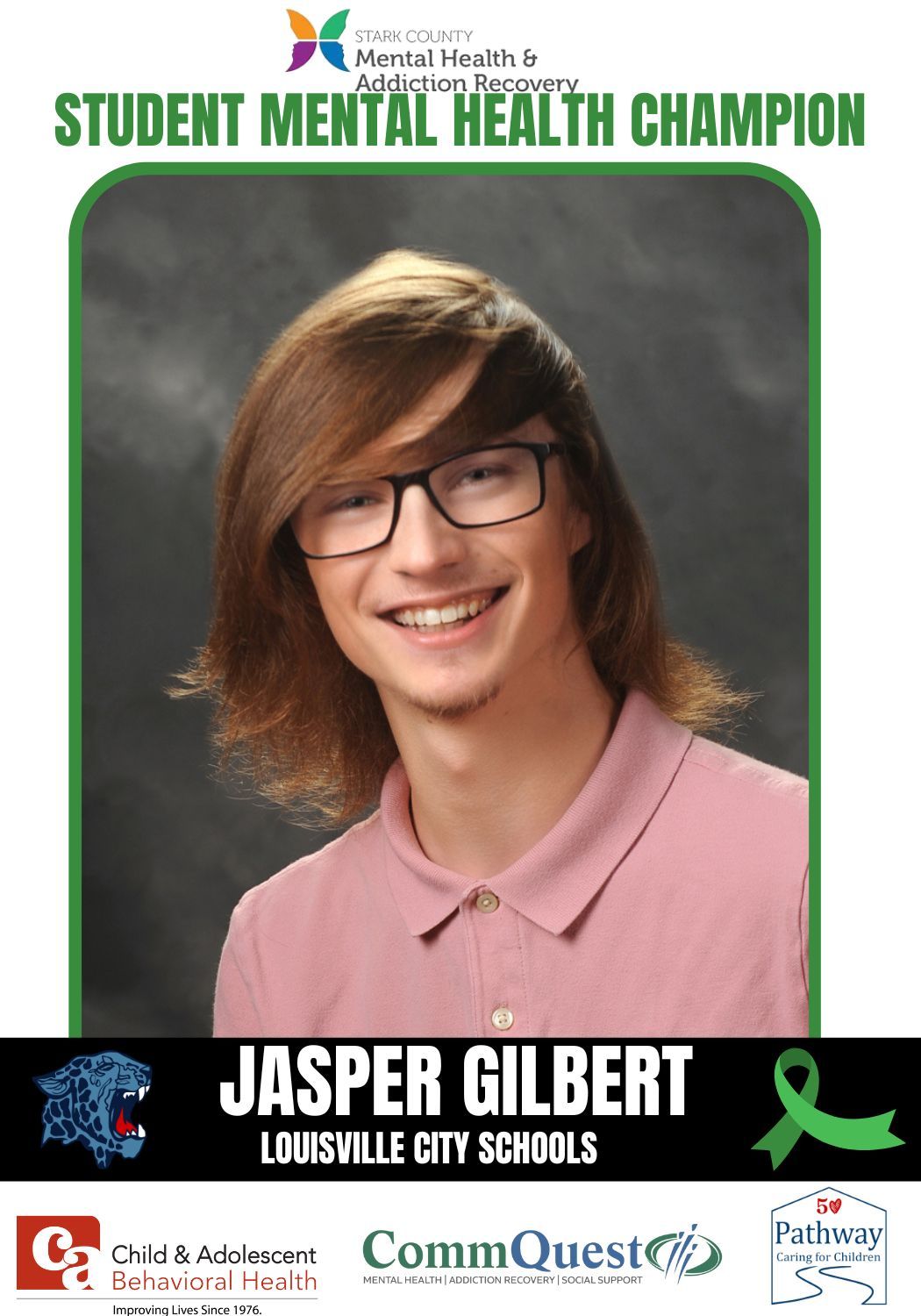 Student Mental Health Champion, Jasper Gilbert, smiling, wearing glasses and pink polo, green background.