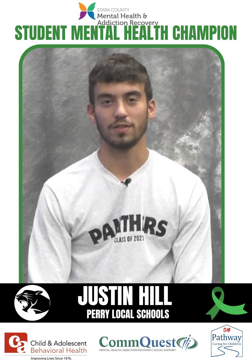 Student Mental Health Champion Justin Hill, wearing a white shirt, stands in front of a green background.