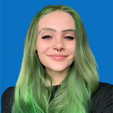 Woman with brown hair smiling, wearing pearl earrings, against a blue background.