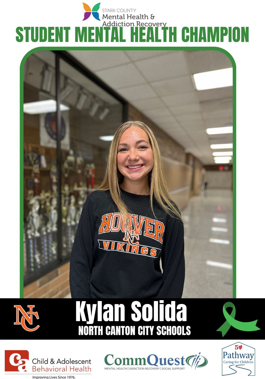 Student Kylan Solida, smiling, in school hallway, named Student Mental Health Champion.