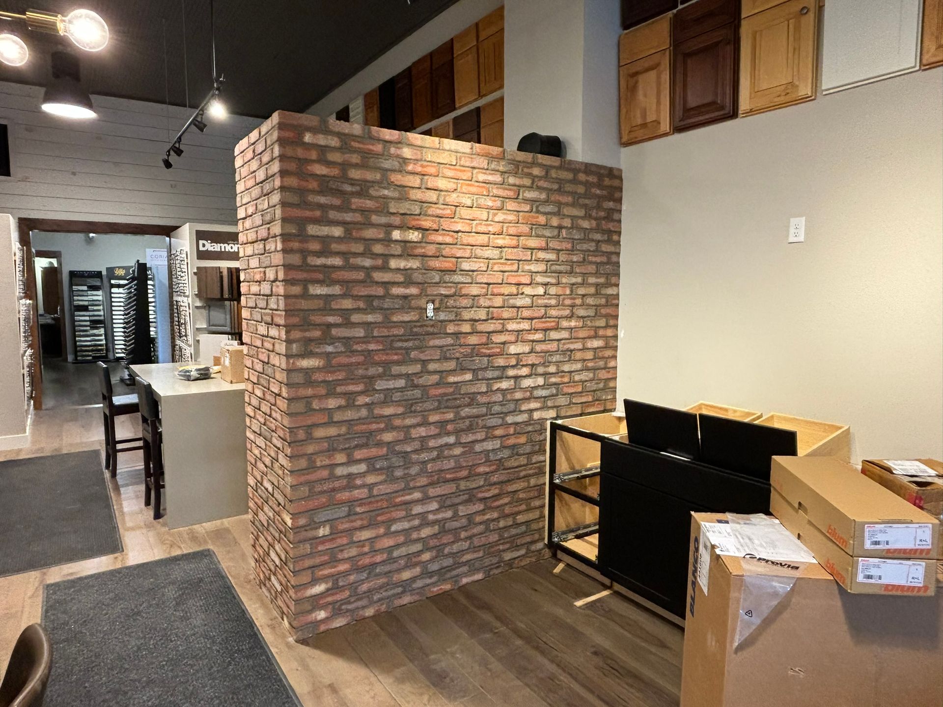 A fireplace with a pile of logs in front of it.