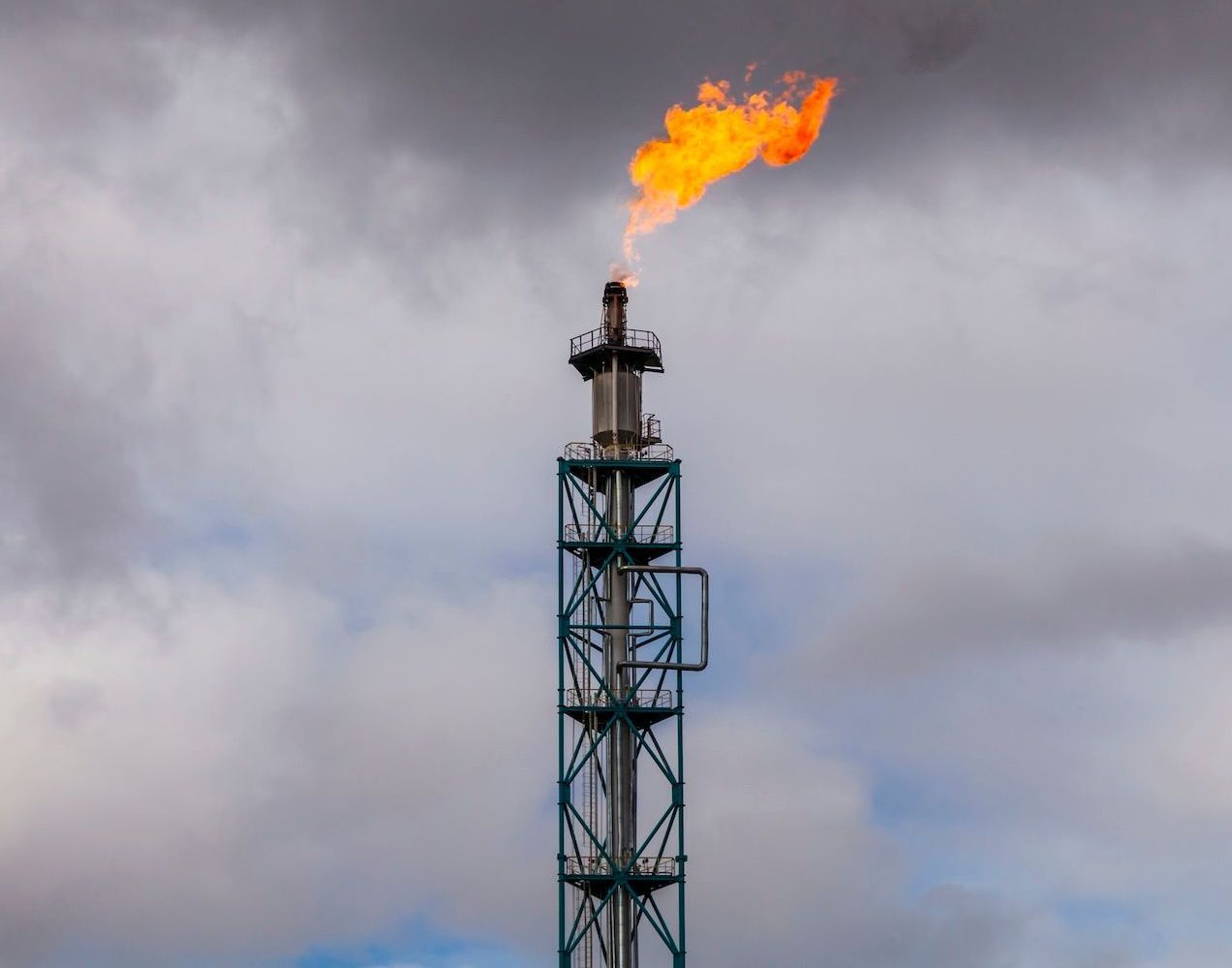 Natural gas tower with flames needs monitoring.