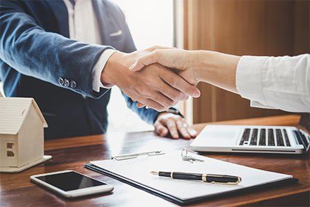 Real Estate Agent and Customers Shaking Hands — Woodsfield, OH — Smith Law Firm