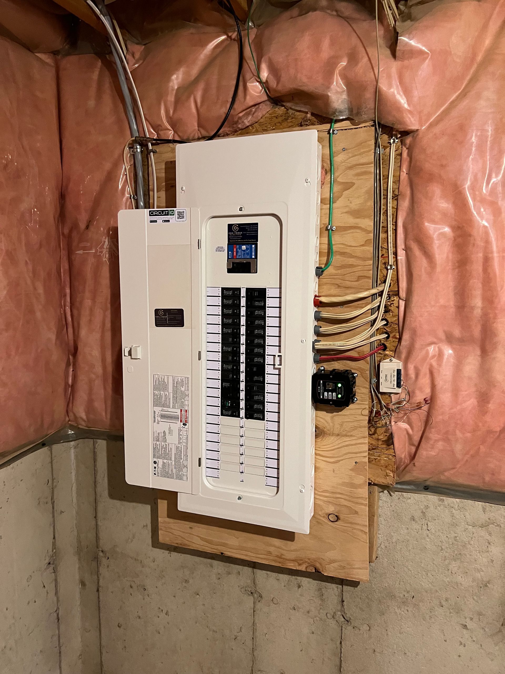 A white electrical box is hanging on a wall in a room.