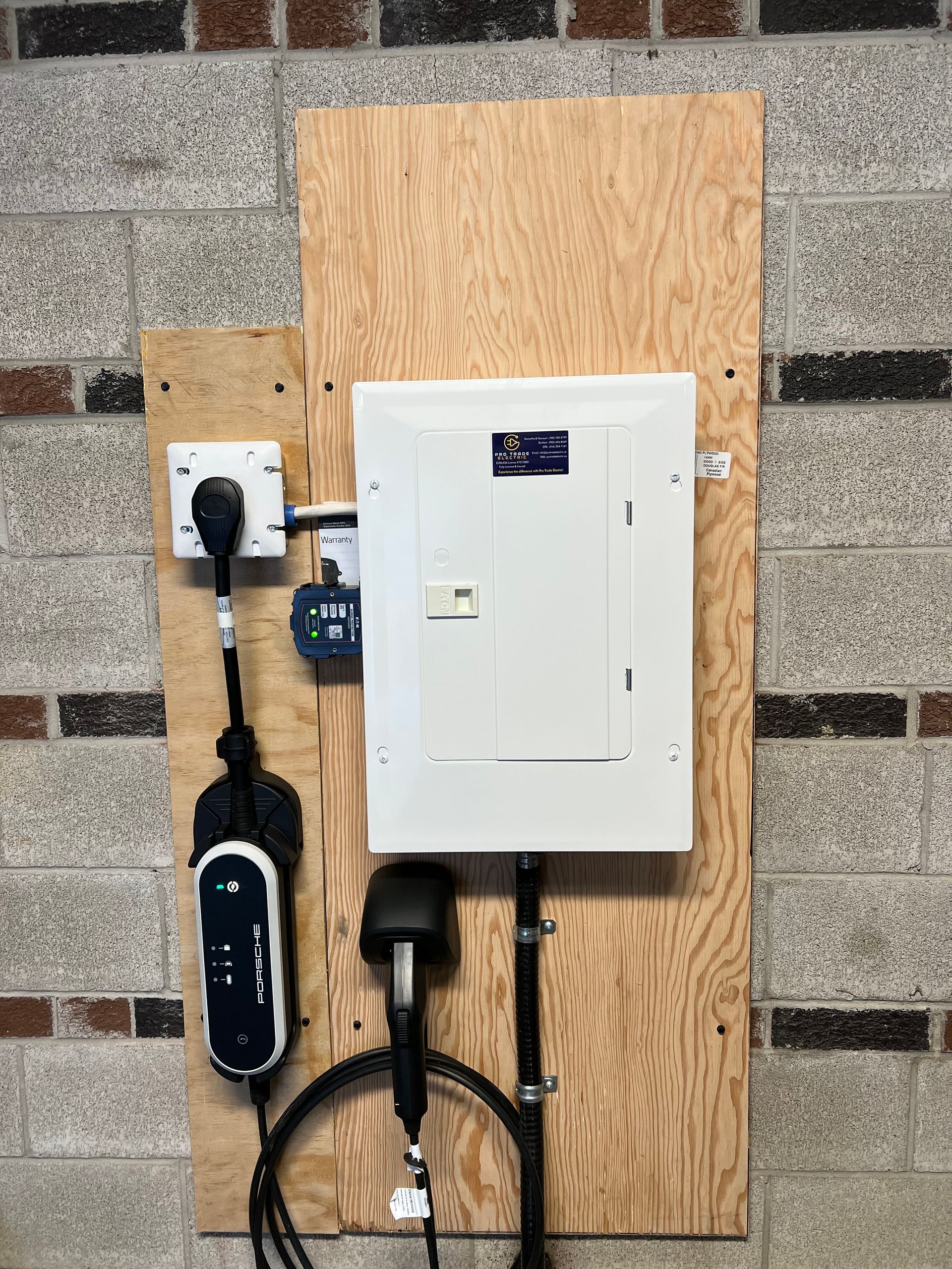 A wooden board with a electrical box attached to it.