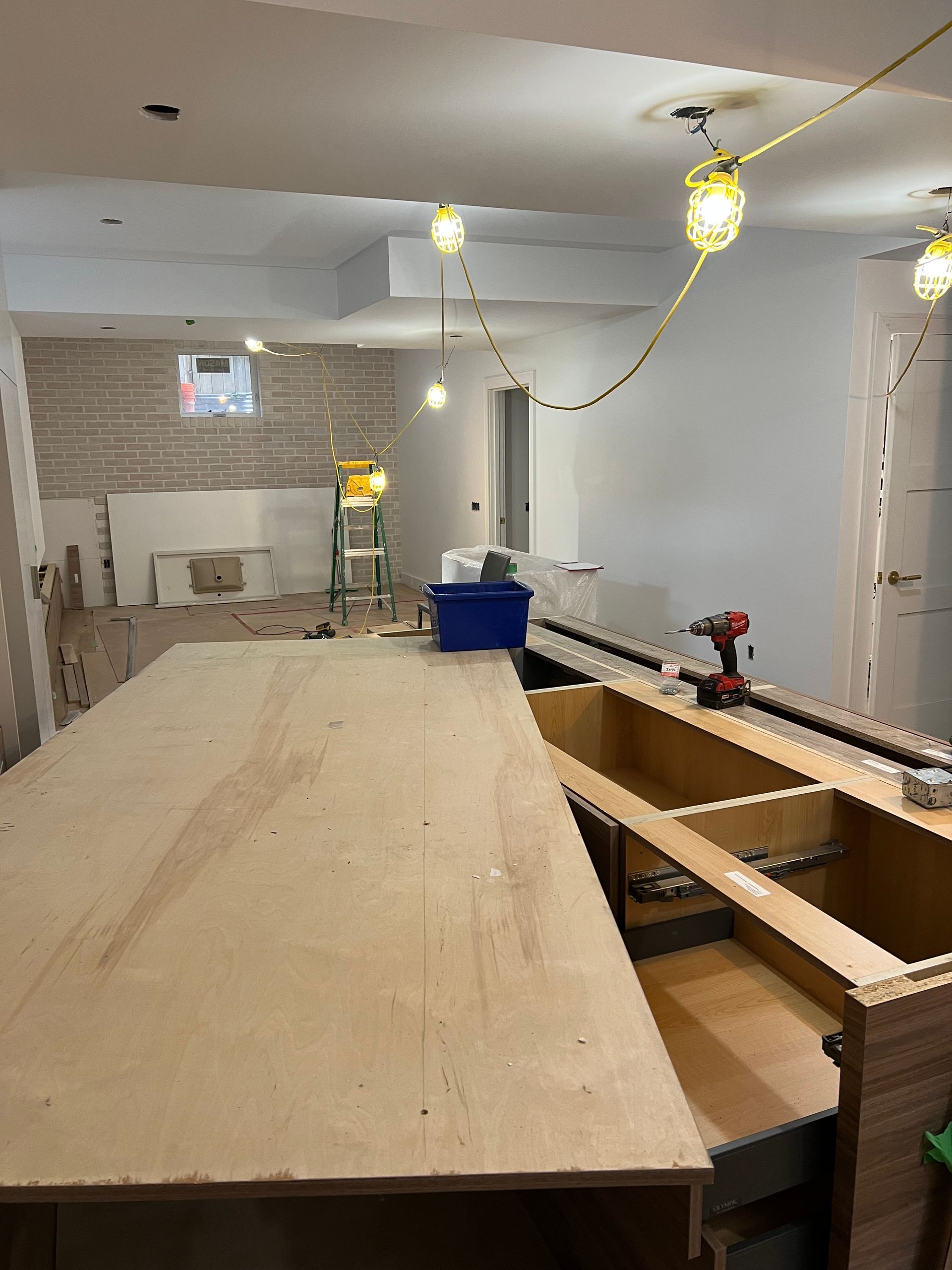 A large wooden table is being built in a room.