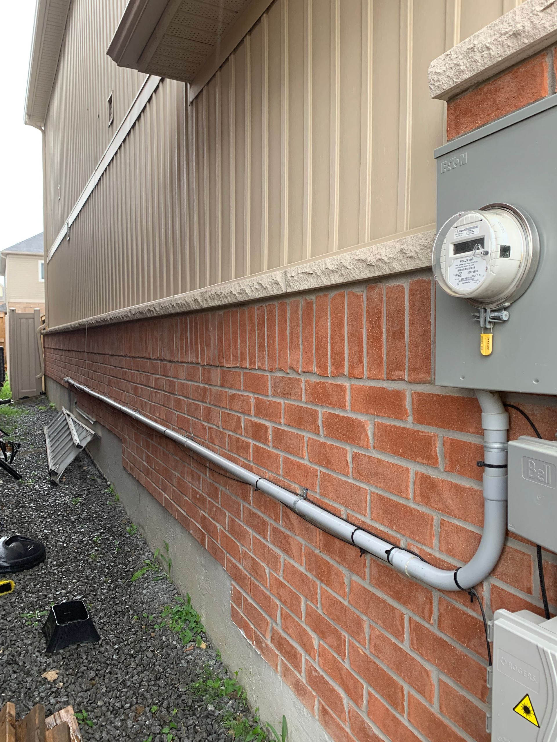 A brick wall with a meter attached to it.