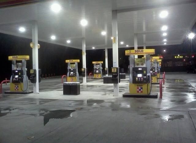 A row of gas pumps at a gas station that says shell