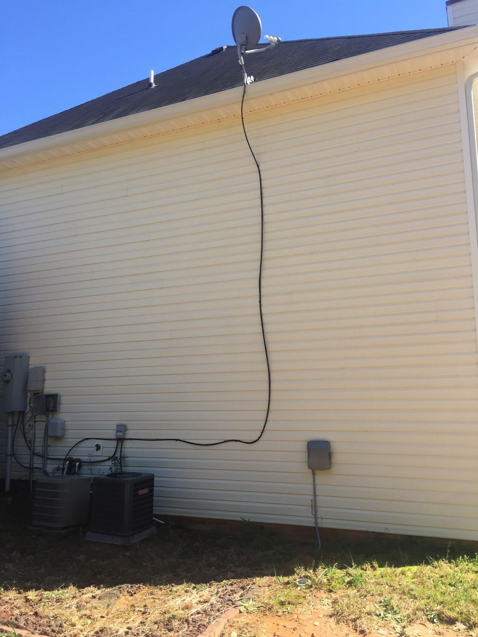 A house with a satellite dish on the side of it