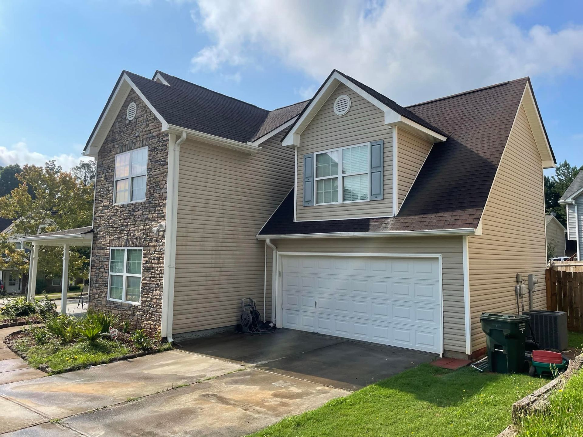A large house with a garage and a lot of windows