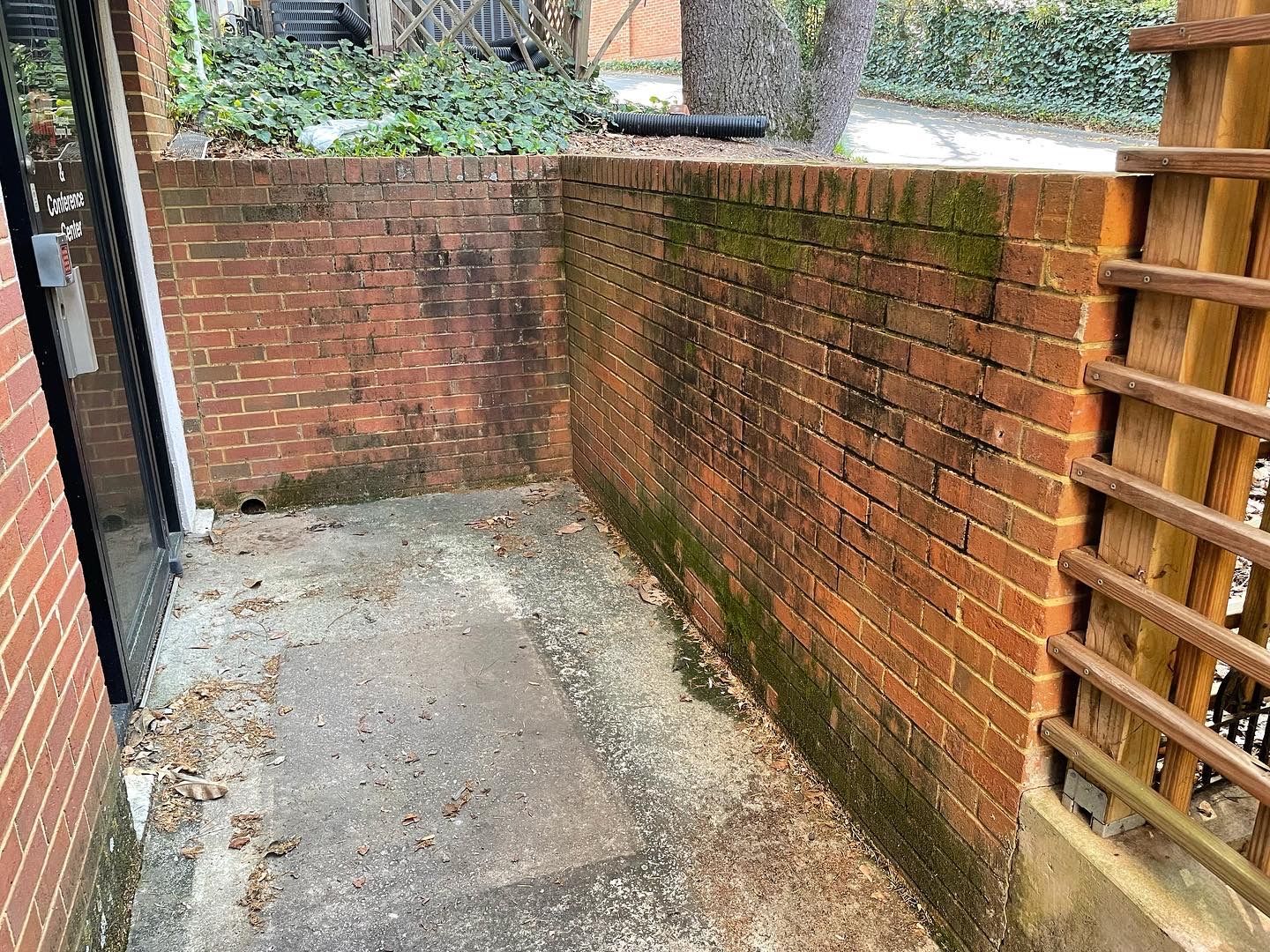 A wooden fence with a metal pipe in the middle of it.