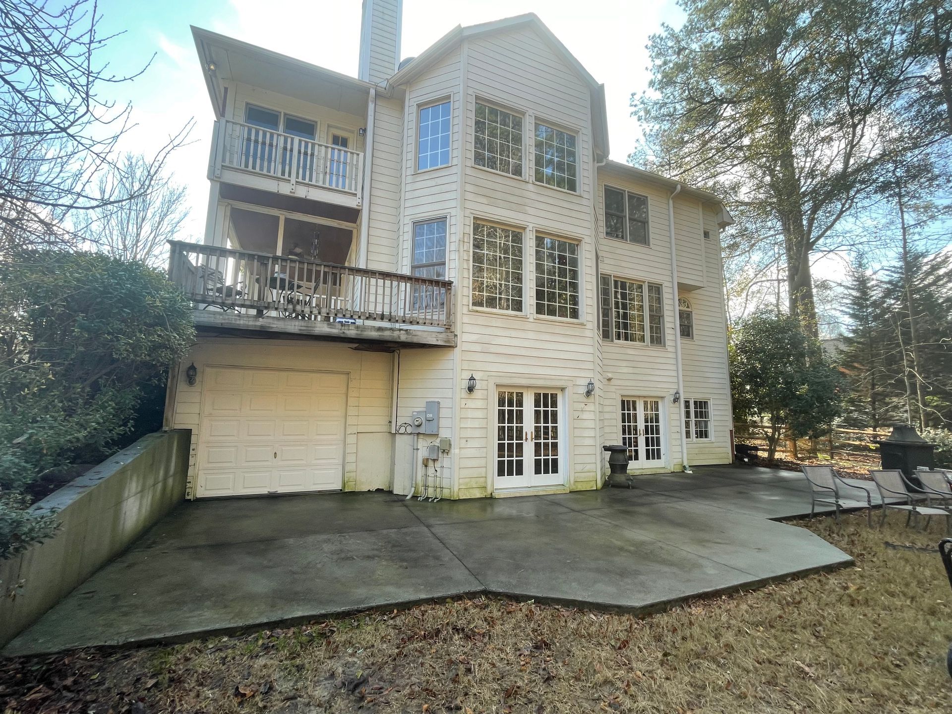 A concrete walkway leading to the front door of a house.
