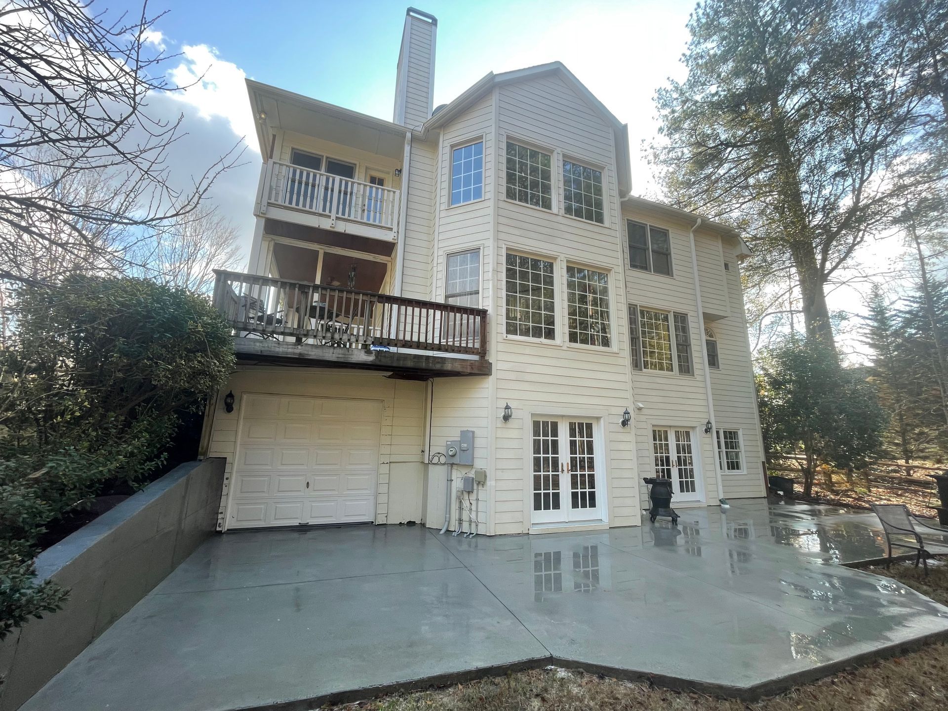 A concrete walkway leading to the front door of a house.