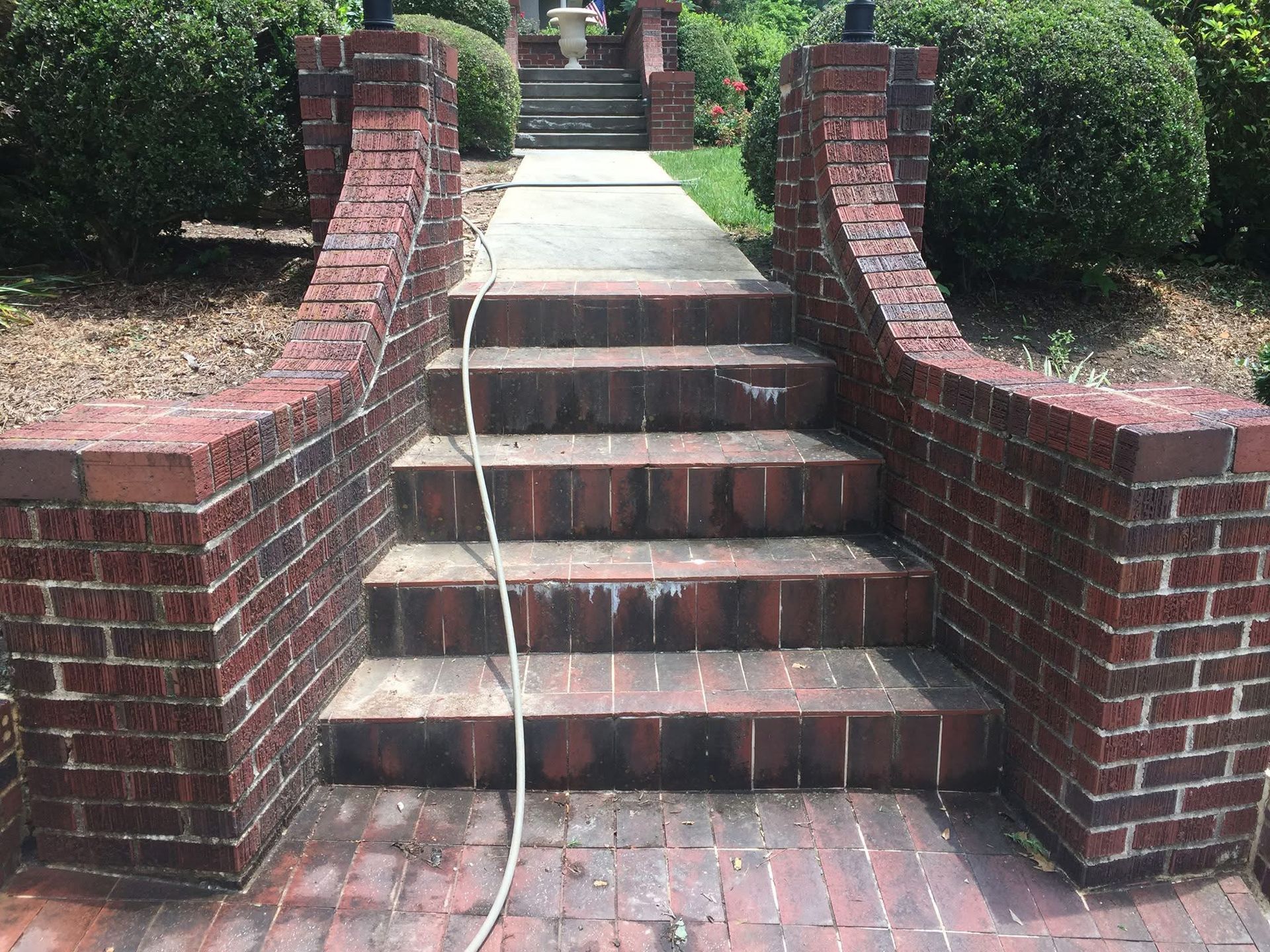 A white house with stairs leading up to the front door