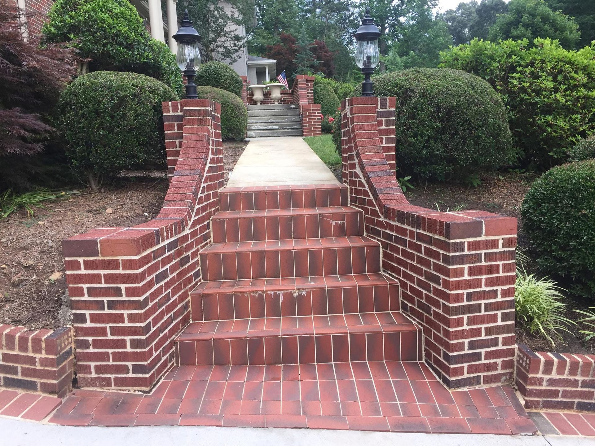 A white house with a wooden deck and stairs