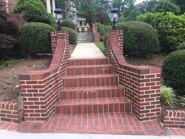 A set of brick stairs leading up to a house