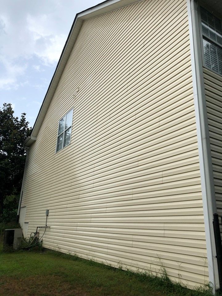 The side of a house with a lot of windows and siding.