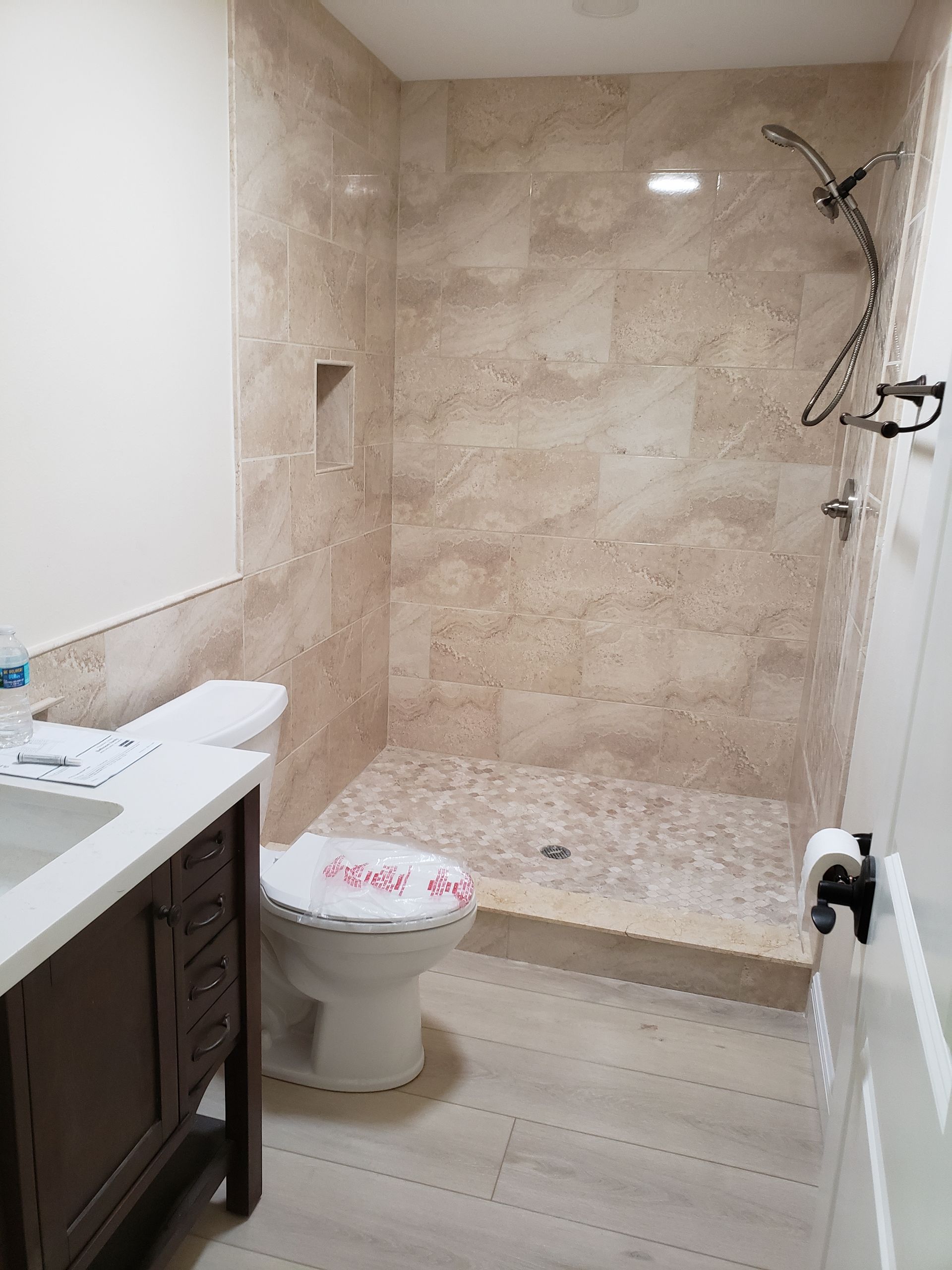 a bathroom with two sinks , a tub , and a large mirror .