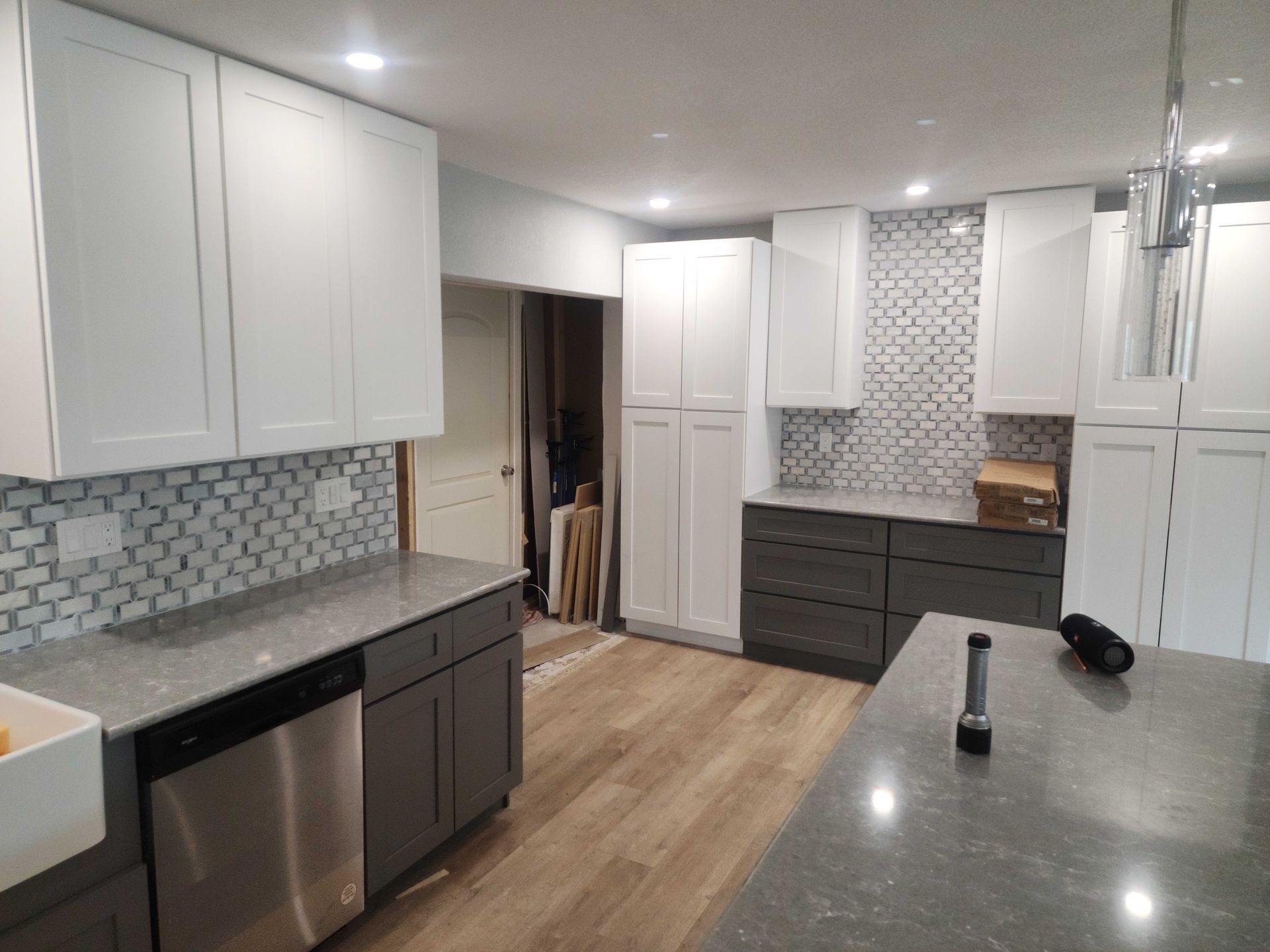 a kitchen under construction with a large island in the middle .