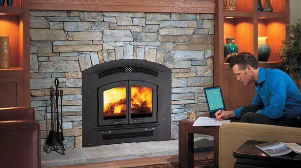 Man using laptop next to large wooden fireplace — Freehold, NJ — Fireside Pros
