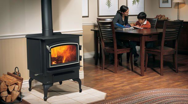 Large wooden stove warming up house with mom and son — Freehold, NJ — Fireside Pros