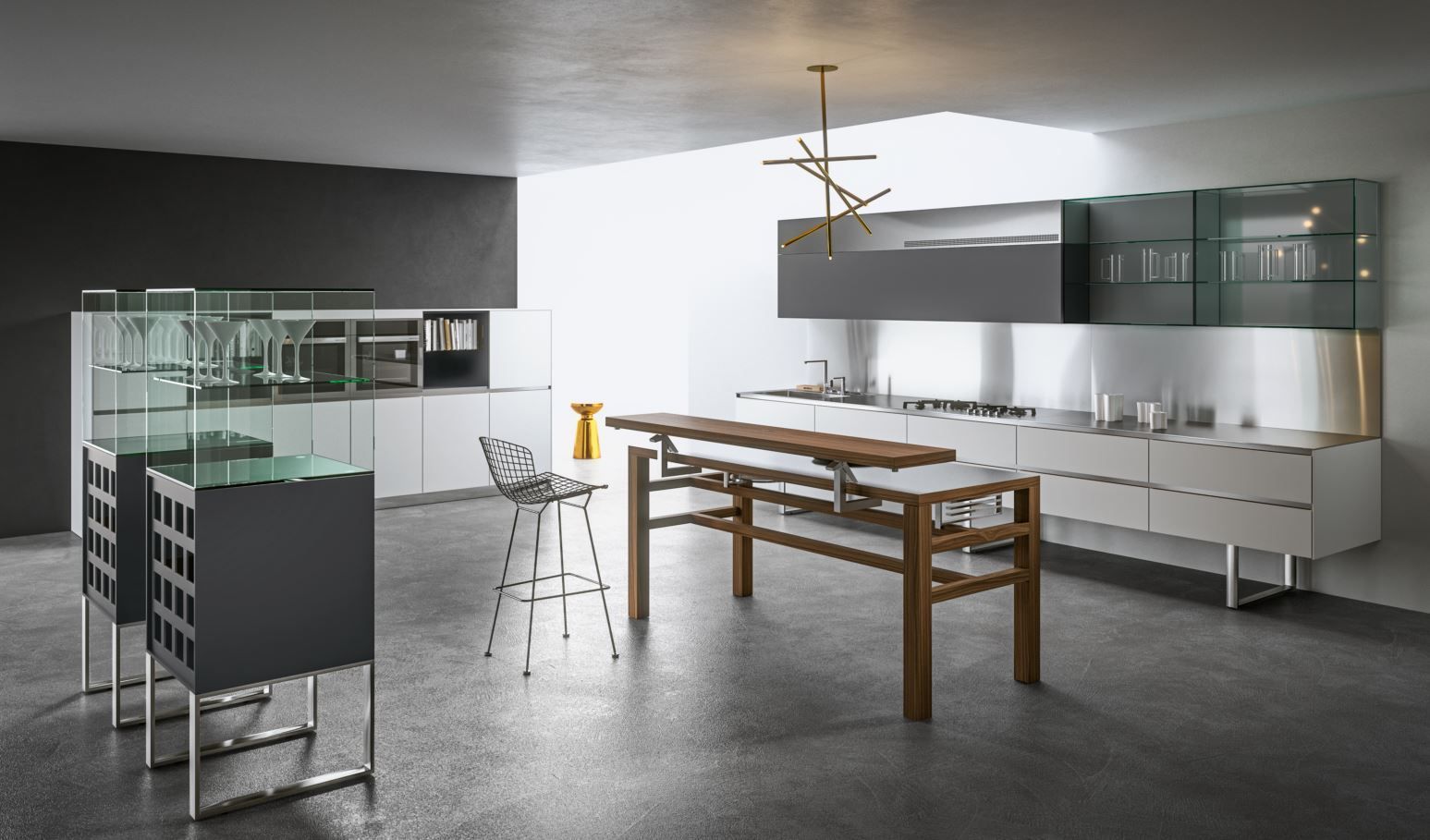 Cucina moderna Aran con mobili grigi, bianchi e in acciaio inossidabile, una lunga isola in legno e un lampadario minimalista.