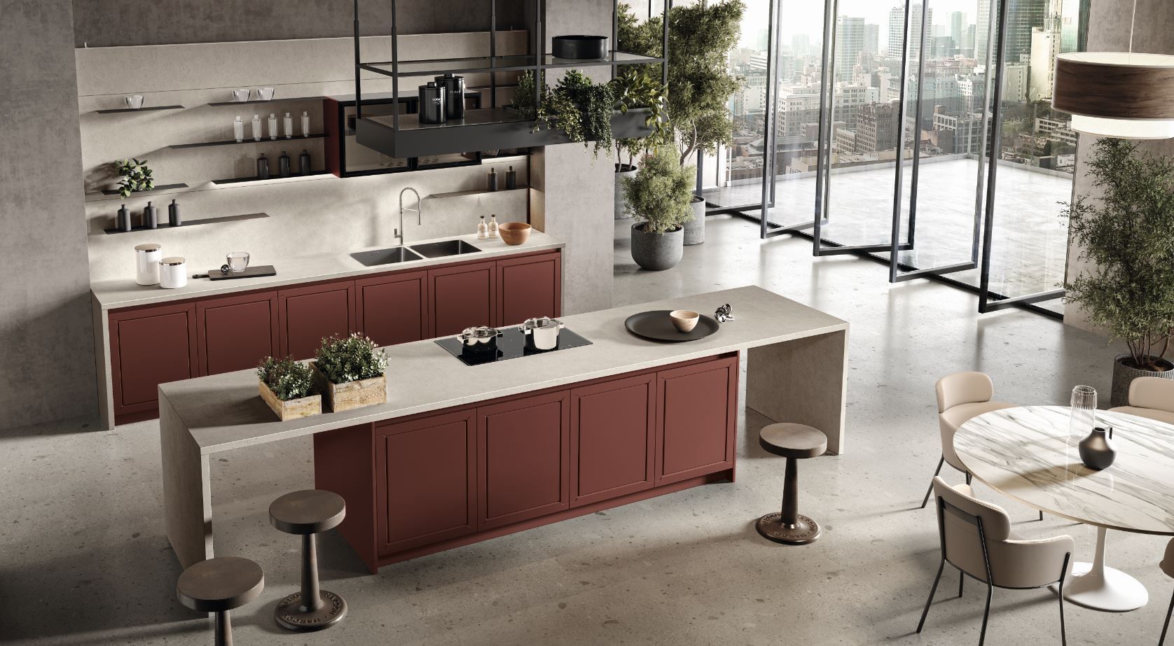 Cucina moderna con mobili rossi, isola, pavimenti in cemento e ampie finestre con vista sulla città.