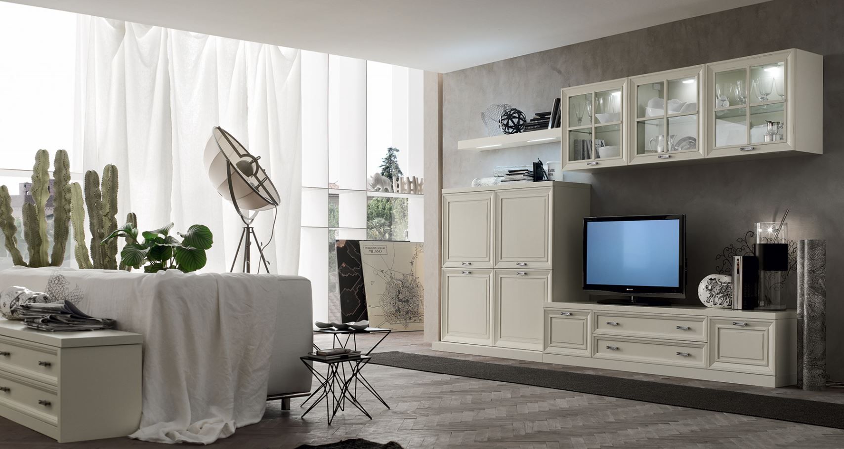 Soggiorno moderno con mobili e decorazioni bianche, tra cui un mobile TV e un divano.