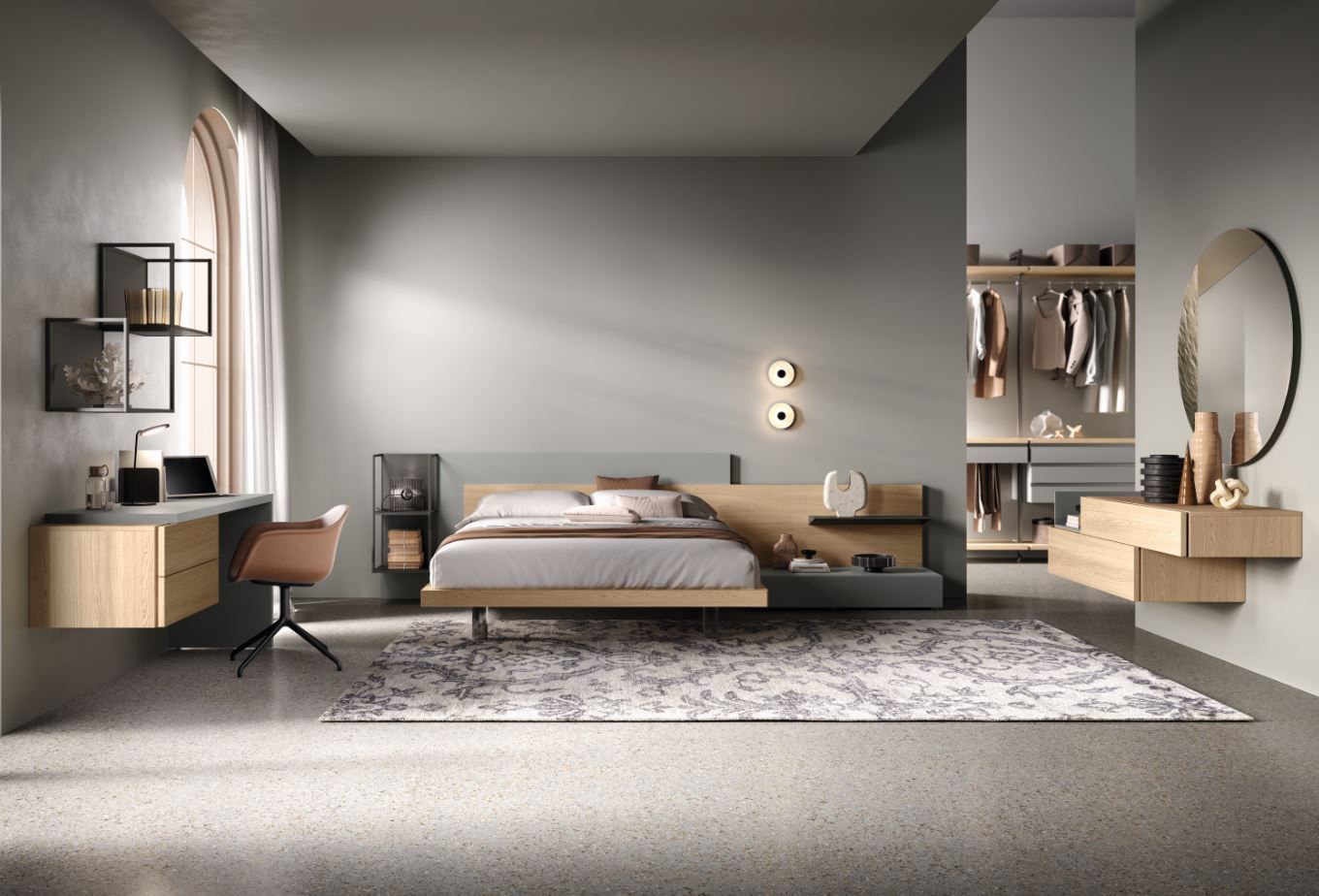 Camera da letto moderna con letto, scrivania, armadio e tappeto; tonalità grigio e legno.