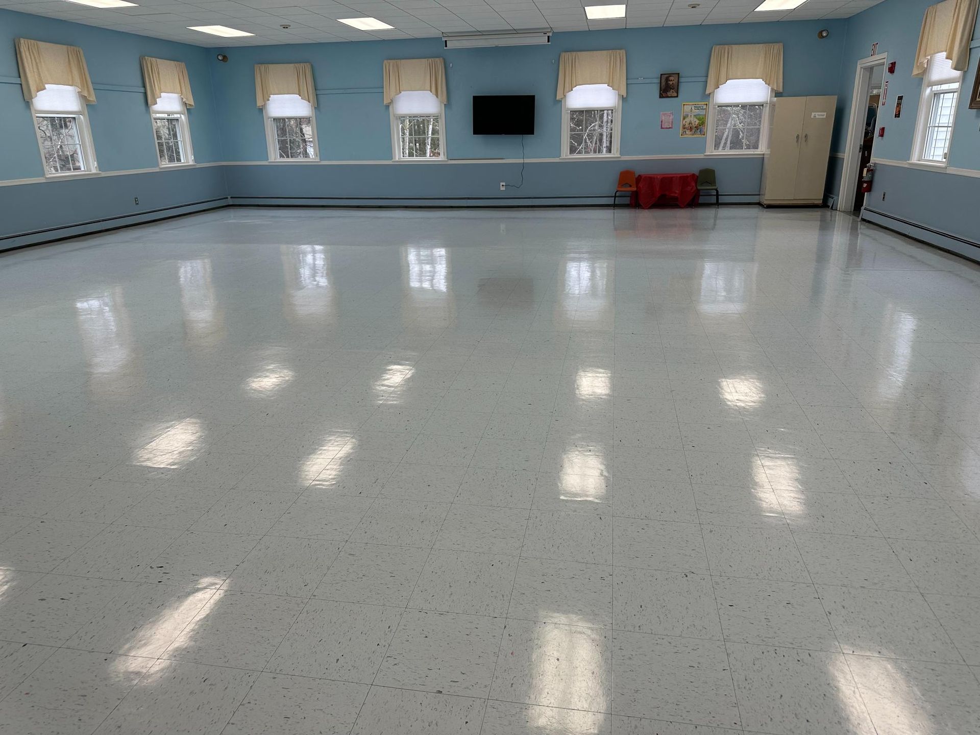Sparkling clean multipurpose room with polished flooring and natural light after janitorial services in Barnstable, MA.
