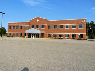 A large brick building with the number 146 on it