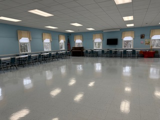 A large room with tables and chairs in it