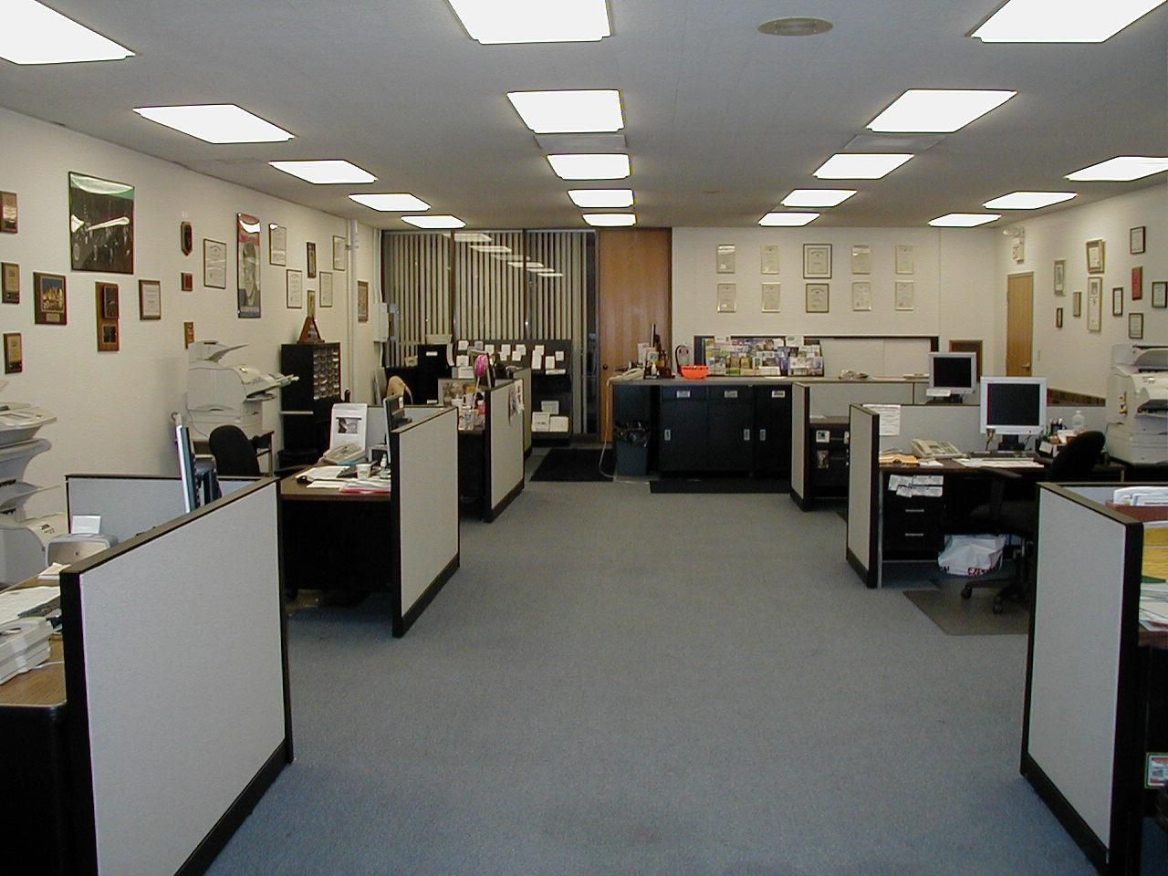 A large office with many cubicles and computers