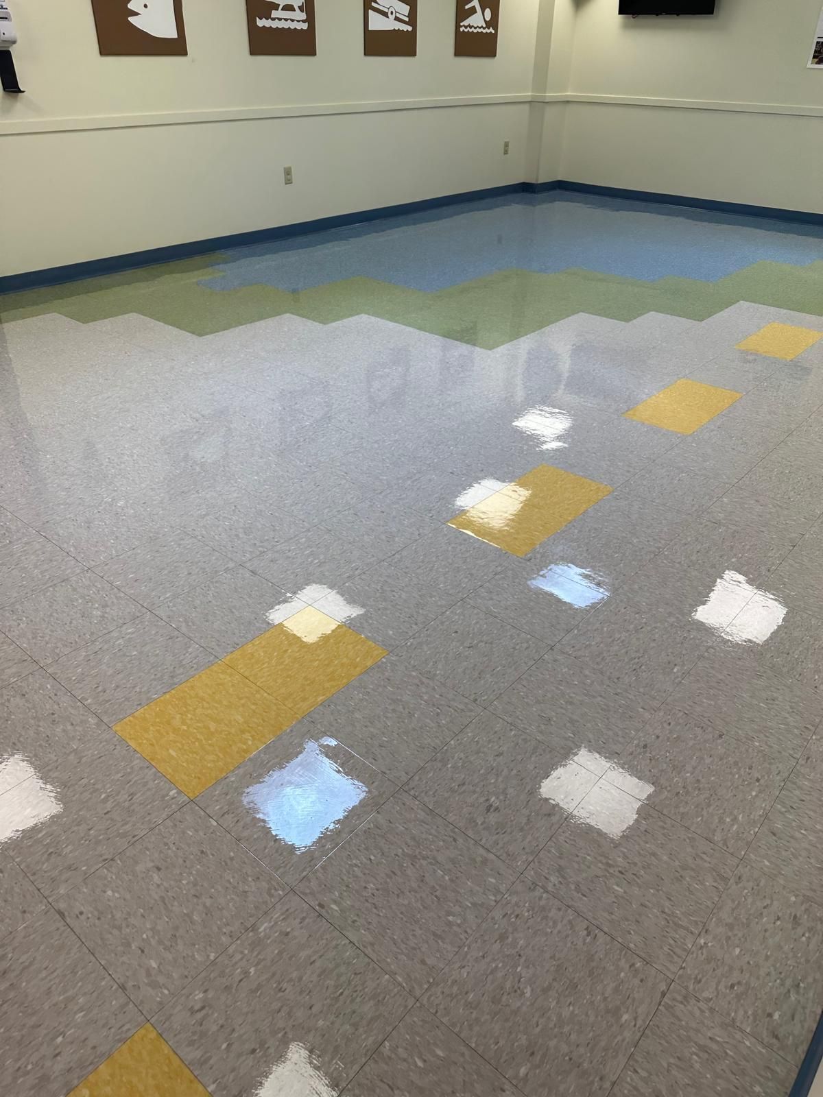 Pristine commercial hallway floor with safety-themed wall graphics