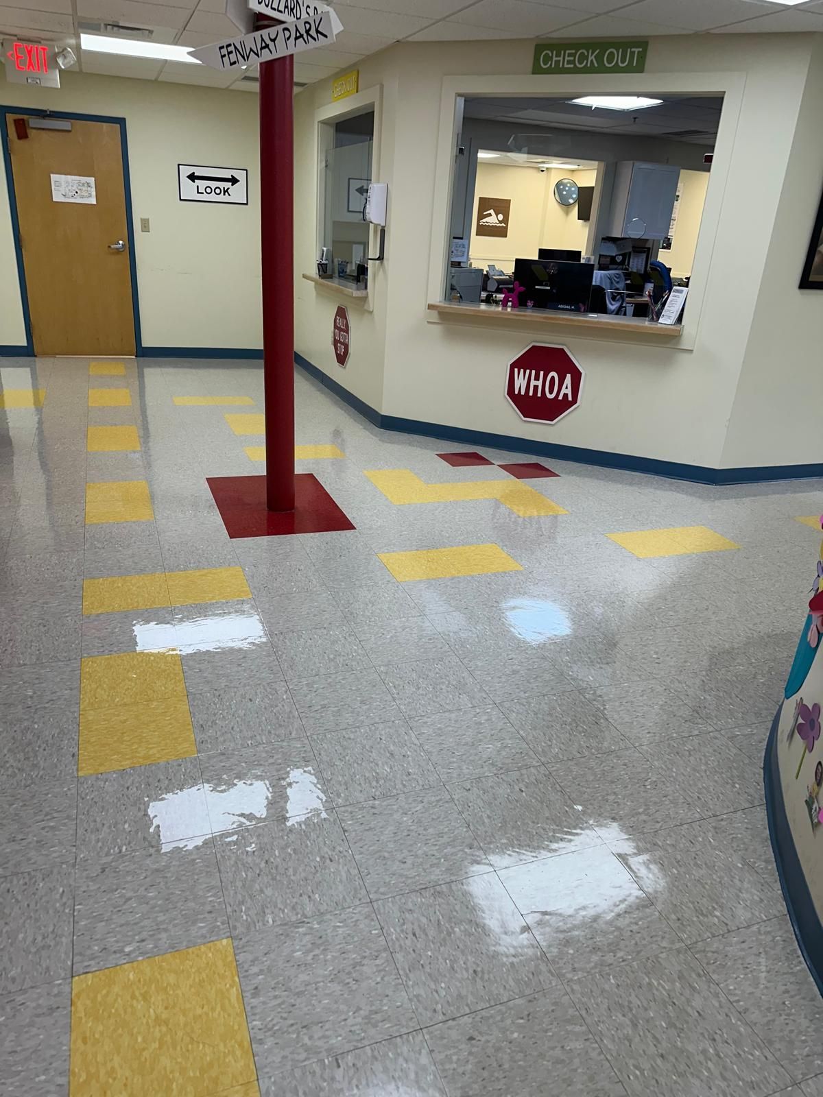 Janitorial service result in a bright, polished corridor with yellow tiles