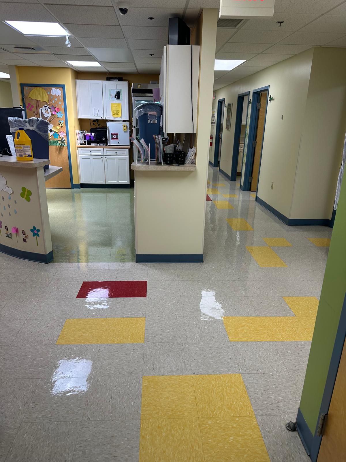  Shiny commercial floors with red and yellow accent tiles after cleaning