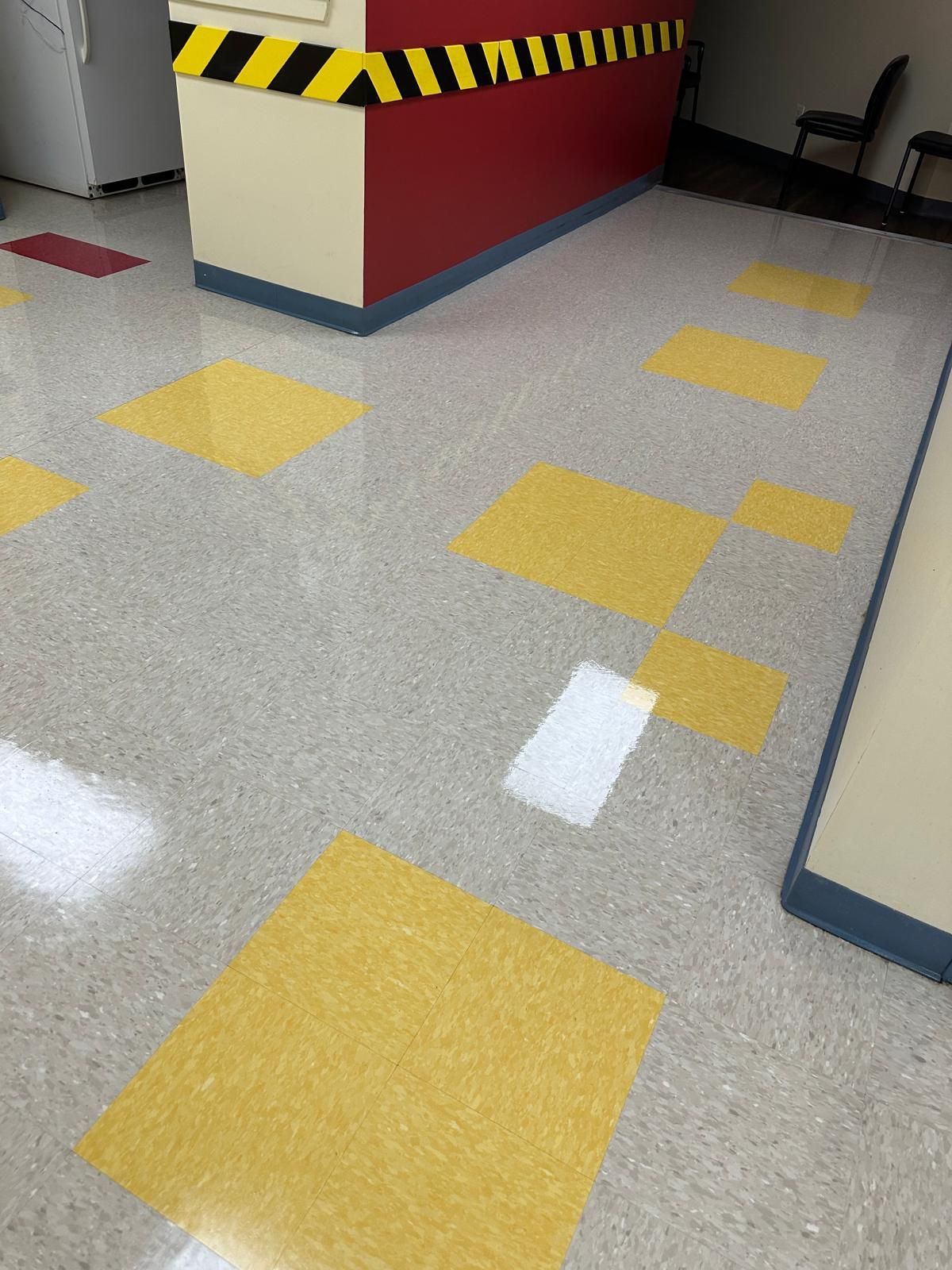 Clean, reflective vinyl tile floors in a clinic reception area