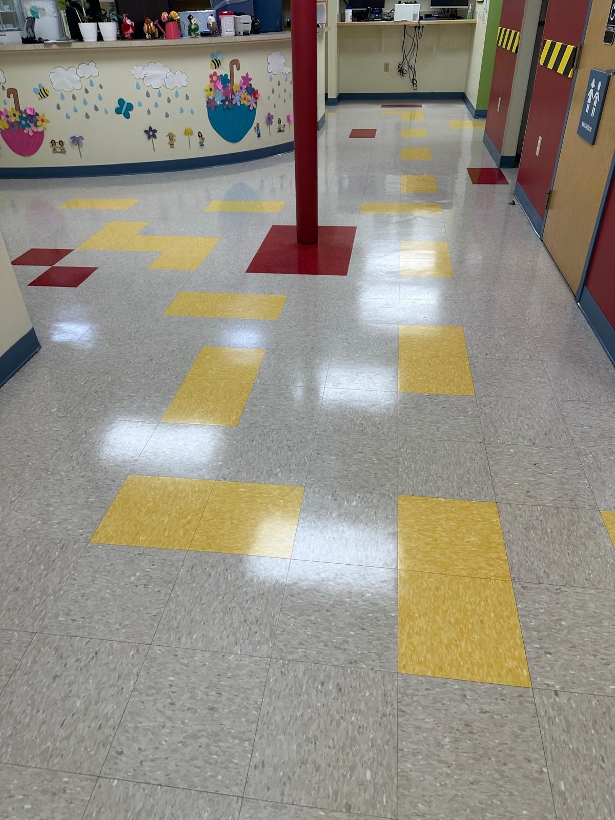 Spotless commercial hallway floor with polished finish and safety signage