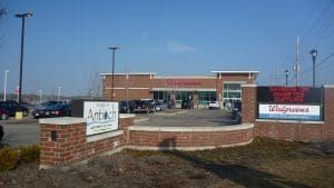 Walgreens storefront with brick entrance. Sign with